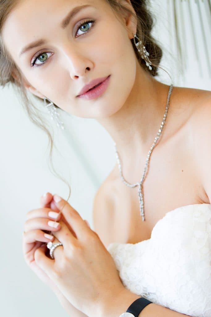 The-model-wearing-the-Tiffany-Setting-ring,-Shared-Prong-wedding-band,-Legacy-necklace-and-Jazz-earrings