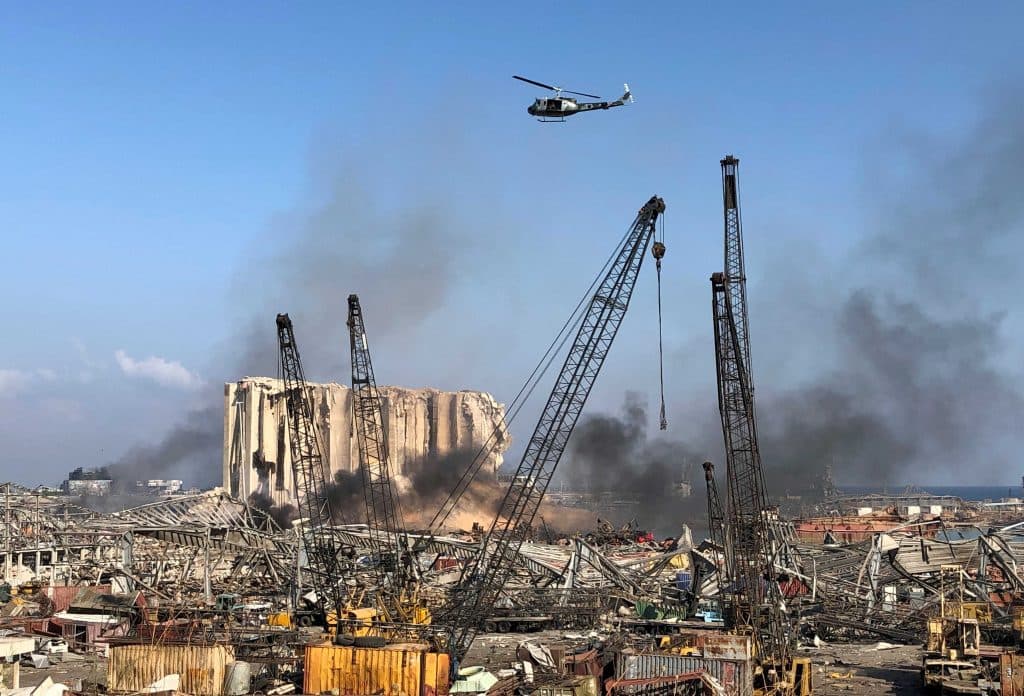 A Lebanese army helicopter flies over the site of Tuesday’s blast in Beirut’s port area