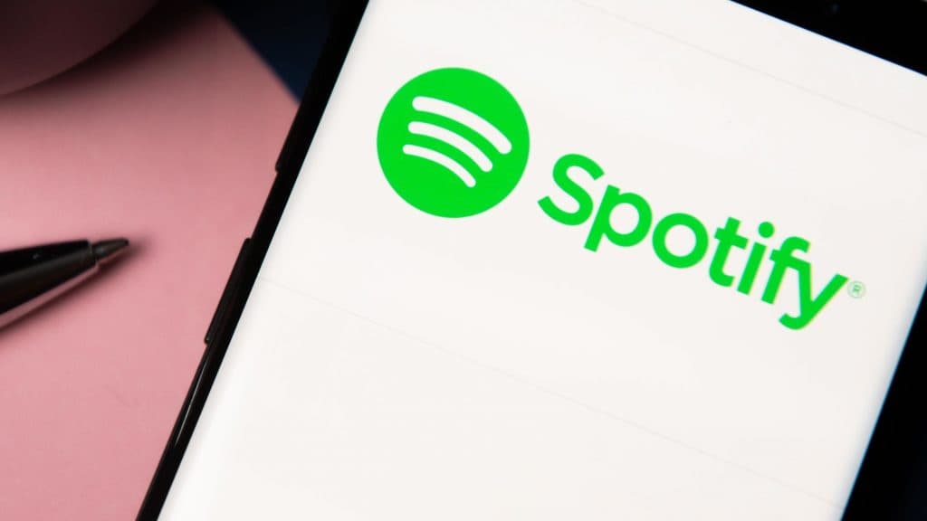 In this photo illustration a Spotify logo displayed on a