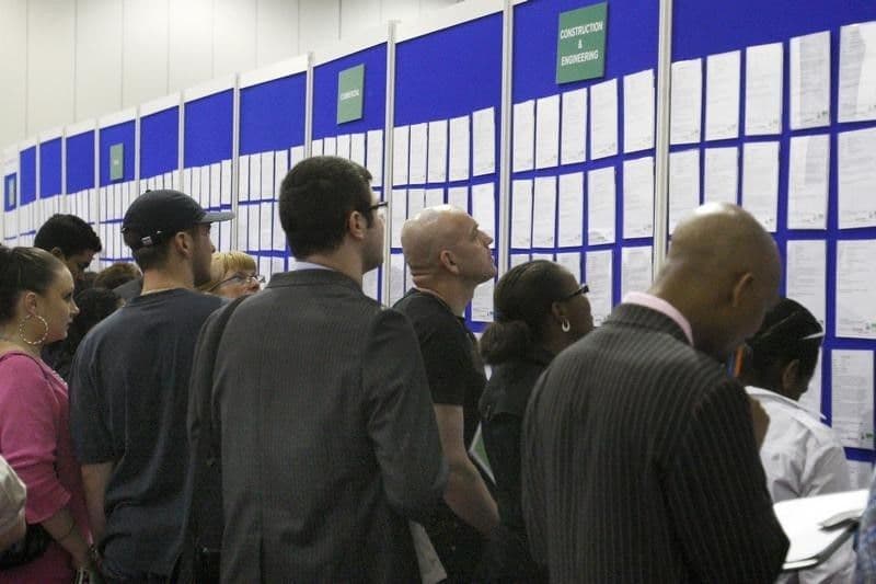 File photo of people look at job listings at the Careers and Jobs Live careers fair at the ExCeL centre in London April 19, 2009.